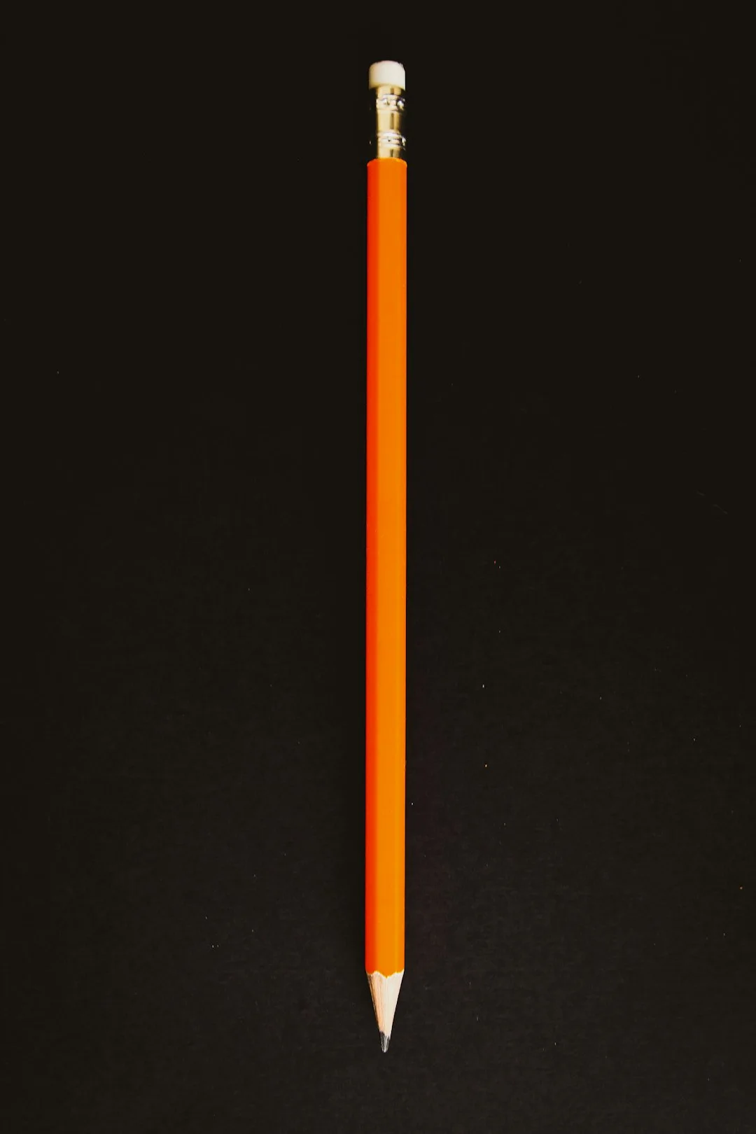 orange pencil on black textile